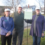 HC President Nancy Collier with Michael and Lili Mayor and our new property sign