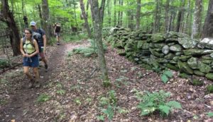 hikers by stone wall