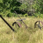 Rusty haying equipment is visible at Huntington Hill